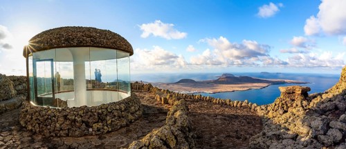 Stairway and viewing platform at the Mirador del RÃ­o viewpoint, in the evening light with sun