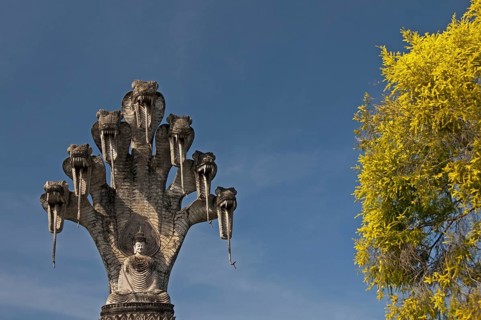 Monumental depiction of Buddha meditating under the protection of a seven-headed naga snake, Wat