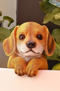 Ceramic dog looking intently in a garden, Wilnsdorf, North Rhine-Westphalia, Germany