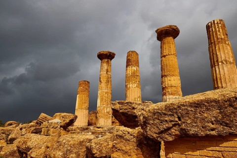 Temple of Heracles, Five ancient columns against dark, looming clouds, Valley of the Temples, Valle