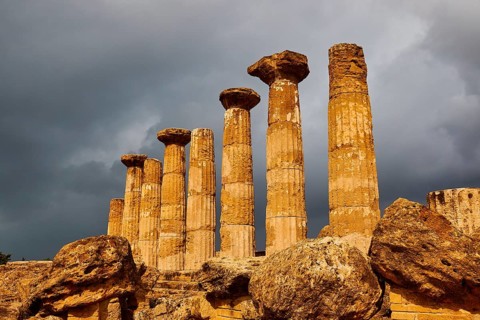 Temple of Heracles, ancient columns under dramatic stormy sky, Valley of the Temples, Valle dei