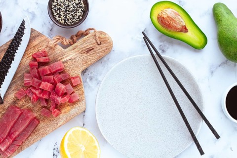 Cooking fresh tuna with ingredients on a marble countertop, ingredients for making sushi and tuna