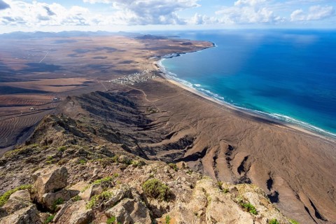 Castillejo viewpoint, view from the Risco de Famara cliffs to the coast and the sea with the Famara