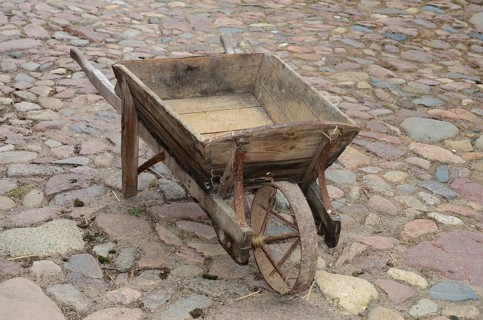 Old-fashioned wheelbarrow on paving stones in Den gamle by, The old village, open air museum in