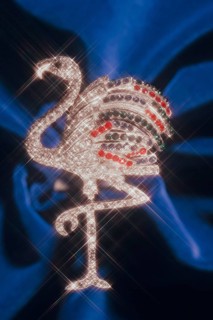 Pelican as rhinestone decoration with blur shot on blue velvet, Bavaria, Germany