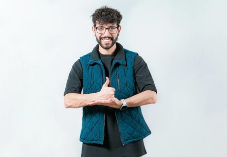 Person gesturing help with hands in nonverbal language. Smiling man showing help gesture with hands
