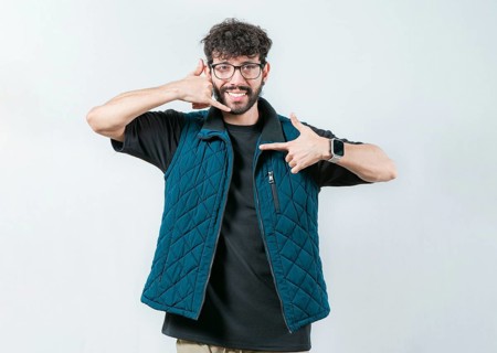 Handsome man gesturing CALL ME in sign language isolated. Person making gesture CALLING in