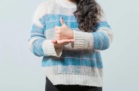 Close up of hands gesturing help in nonverbal language. Hands showing HELP gesture with hands in