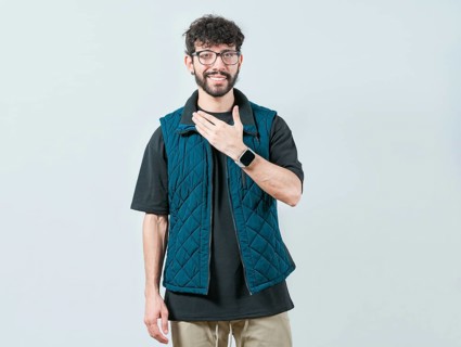 Young man making PLEASE gesture in sign language. Person gesturing PLEASE in nonverbal language