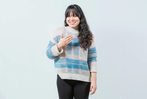 Young asian girl making PLEASE gesture in sign language. Beautiful woman gesturing PLEASE in