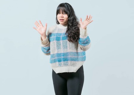 Scared asian woman with raised hands isolated. Young woman scared surprised with raised hands