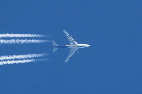 Boeing 747 jumbo jet cargo aircraft of Atlas air airlines flying in a blue sky with contrails or