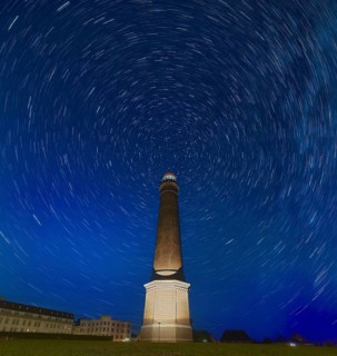 Starry sky above Borkum lighthouse Germany