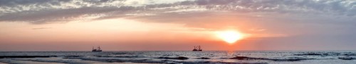 North Sea panorama crab fishermen in sunset mood