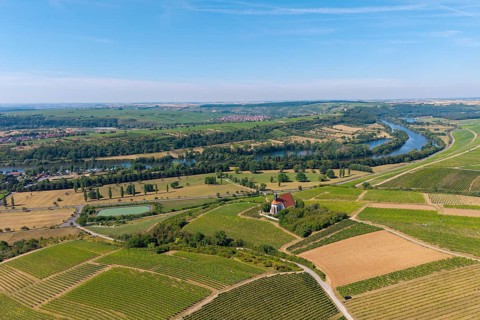 Pilgrimage church Maria im Weingarten, in a wide landscape of vineyards and fields along a large