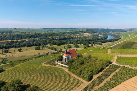 Pilgrimage church Maria im Weingarten, between vineyards, with river and green landscape in the