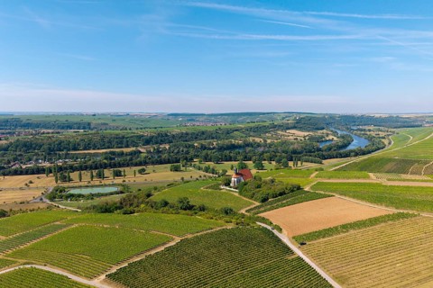 Pilgrimage church Maria im Weingarten, wide landscape view with vineyards, river and fields to the