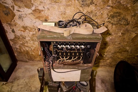 Old telephone in a wooden box with cables, in historical surroundings, war museum, military museum,