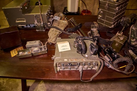 Antique military radio equipment and accessories displayed on a wooden table, War Museum, Military