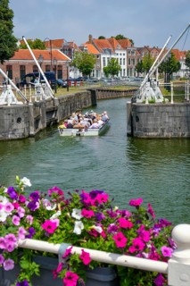 Middelburg, Zeeland, Netherlands - Town houses on the inner harbour in the old town. Tourists take