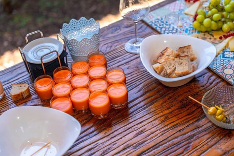 Elegant wedding reception setup featuring appetizers, vibrant decor, and rustic wooden table,