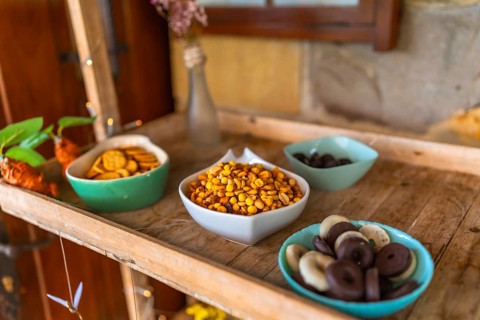 Colorful candy and snacks served on a wooden tray during a wedding celebration, adding a touch of