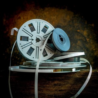 Old film strip reel showcasing vintage cinema history and its storytelling essence in a rustic