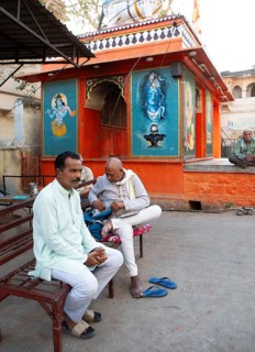 Indian men in white clothes at a colourful temple in the old town, Bundi, Rajasthan, India