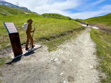 Information board on the left next to the Alpine Pass border pass road on early history and pass