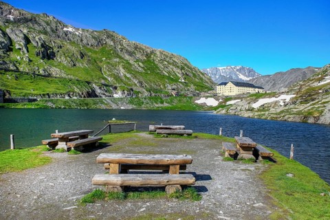 View of small island with wooden benches in mountain lake Alpine lake Lac du Grand Gd Saint St