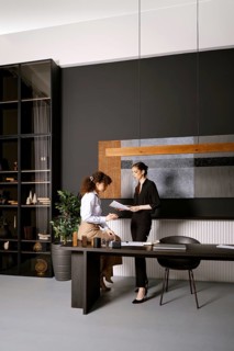 Two businesswomen are looking for a solution of an issue reading papers in an office. One woman