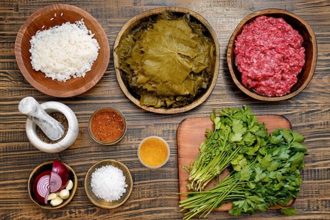 Ingredients to make dolma at home. Grape leaves, minced meat, rice, and various spices and herbs