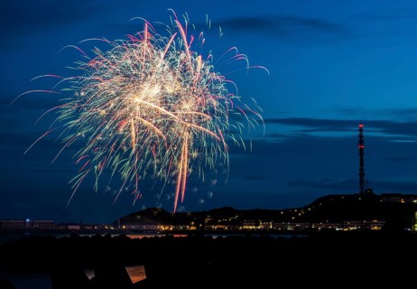 Brilliant, atmospheric fireworks display for the Heligoland island festival in red, blue and gold,