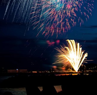Brightly shining atmospheric fireworks for the Helgoland island festival in red, blue and gold over