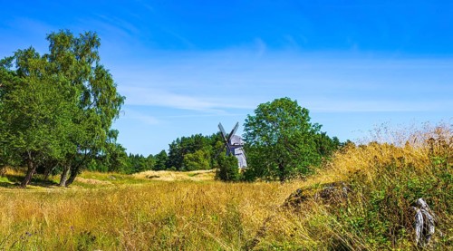Epic summer landscape with historic windmill near the burial ground of Stenhusbacken and the