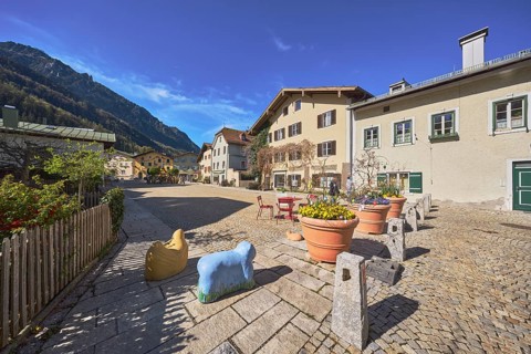 Old town, historic houses, square, cobblestones, bollards, wooden fence, facade, windows, bushes,
