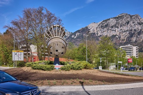 Saltworks roundabout, stainless steel sculpture, salt shaker, trees, lantern, car, mountains,