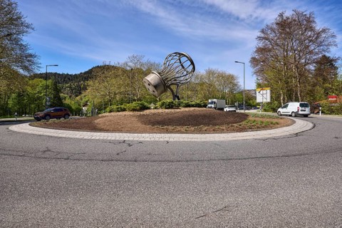 Saltworks roundabout, lantern, trees, vehicles, stainless steel sculpture salt shaker, blue sky,
