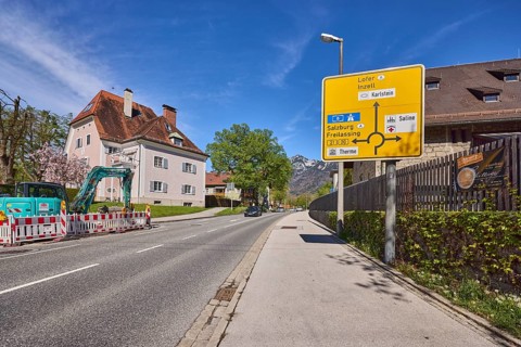 Signposts to Lofer, Inzell, Salzburg and Freilassing, road, house, lantern, trees, lawn, fenced-off