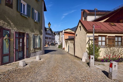 Historic houses, lantern, facade, windows, doors, alleyway, cobblestones, bollards, blue sky,