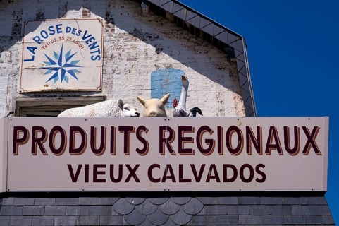 Advertising sign La Rose des Vents. Retail trade, supplier of regional products such as Calvados,