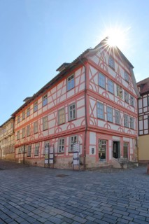 Red half-timbered house against the light, Lutherhaus, Lutherplatz, Schmalkalden, Franconia,