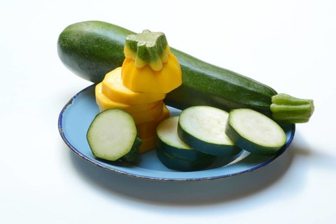 Green and yellow courgettes on a plate, Cucurbita pepo