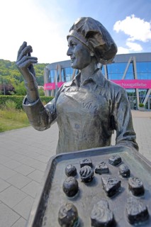 Sculpture confectioner with tray full of pralines for tasting, presentation, eating, enjoyment,