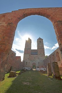 Romanesque St. Mary's Collegiate Church backlit with archway, twin towers, church ruins, interior