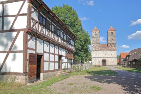 Half-timbered house and Romanesque St Mary's Collegiate Church with twin towers, church ruins,