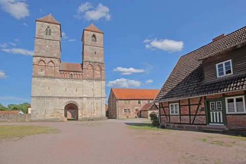 Romanesque St Mary's Collegiate Church with twin towers and half-timbered house, brick building,