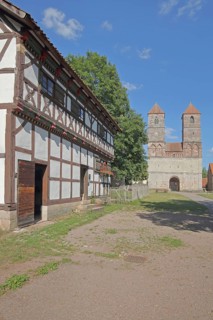 Half-timbered house and Romanesque St Mary's Collegiate Church with twin towers, church ruins,