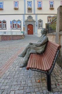 Johann Wolfgang von Goethe by Klaus Gutting sitting on the bench, arms, bronze sculpture, looking,