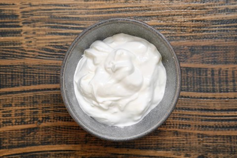Overhead view of a bowl with sour cream or greek yoghurt